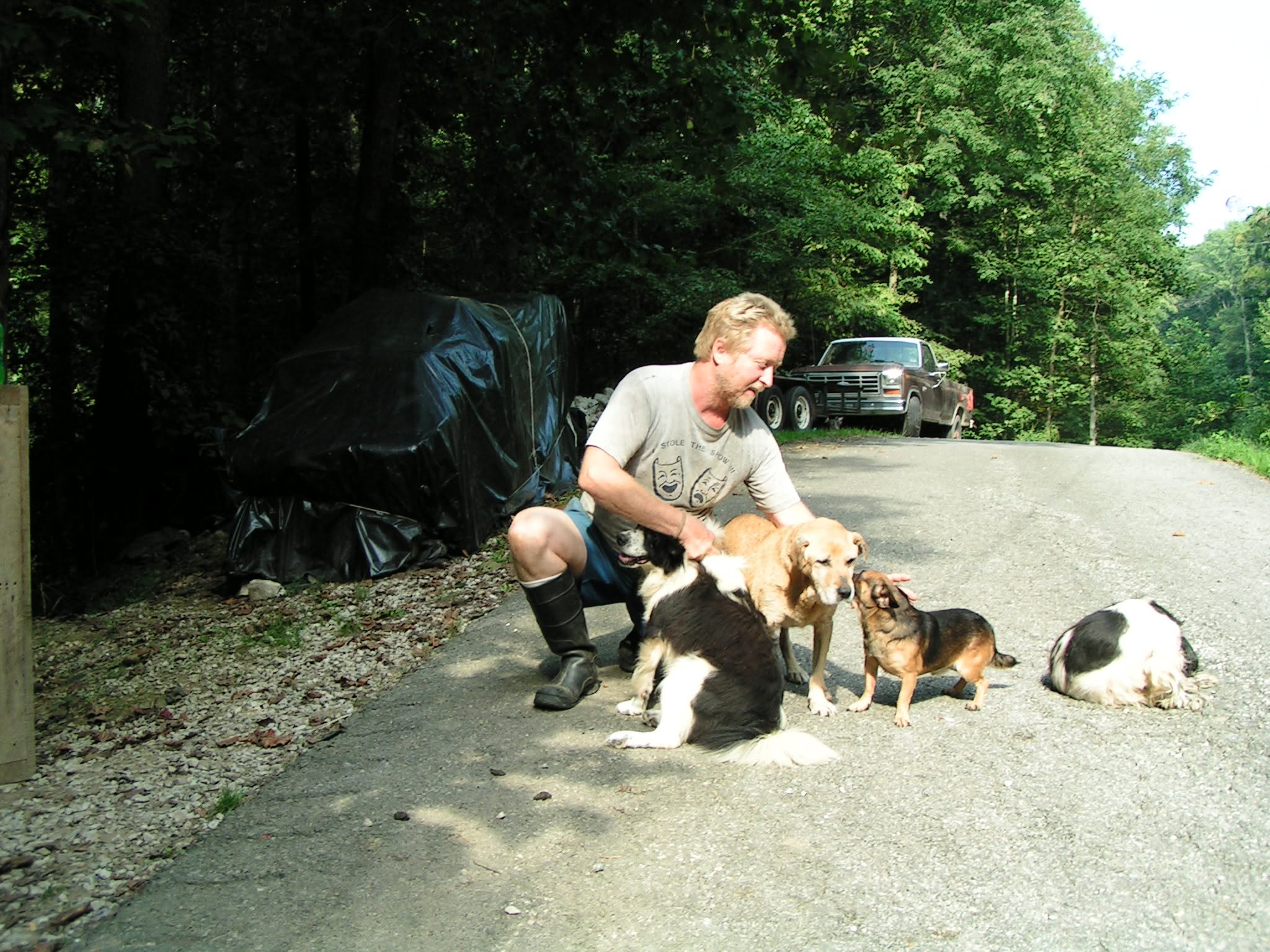 Randy with sanctuary dogs outdoors.